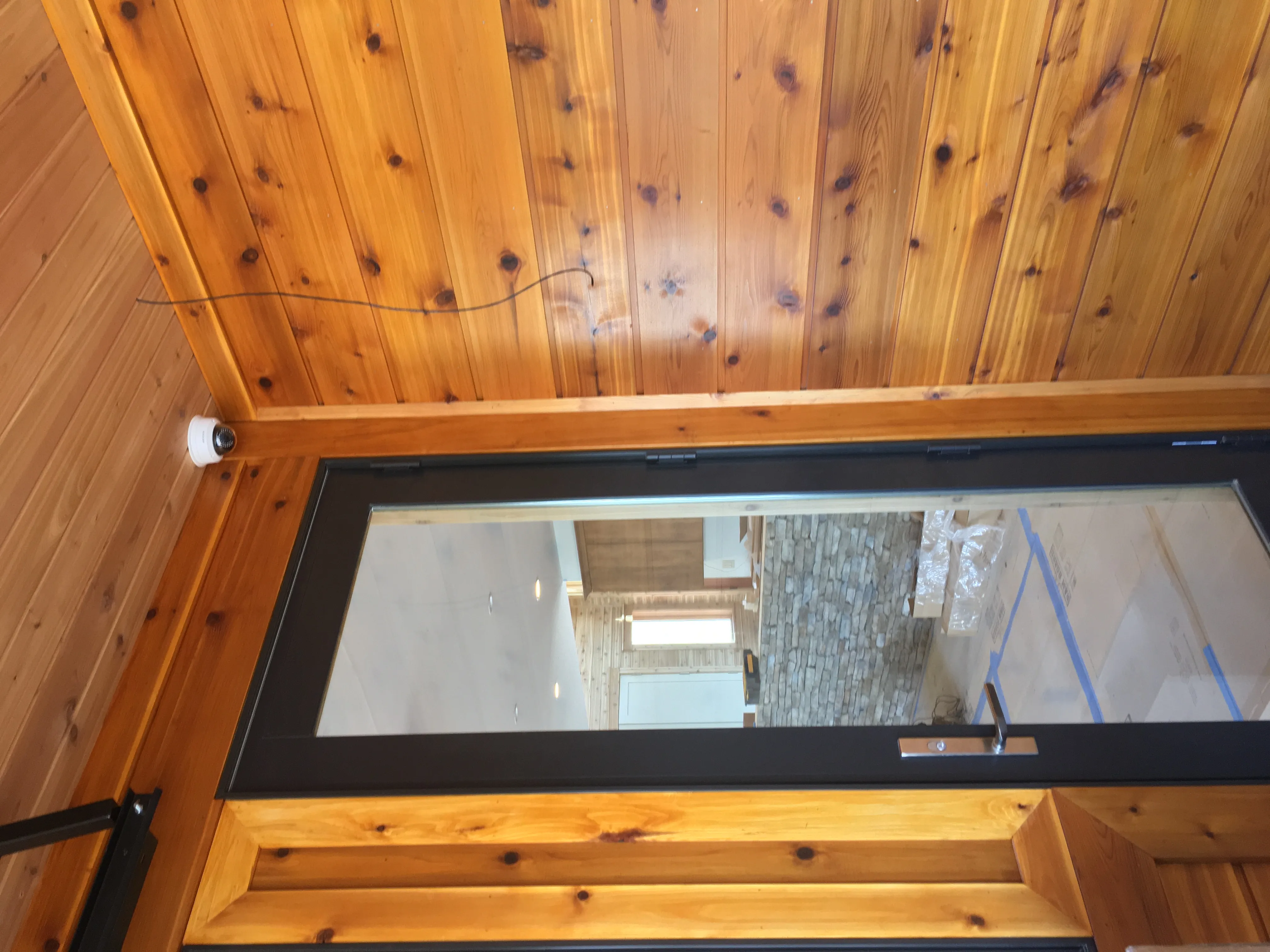 Ceiling-mounted surveillance camera at an entry