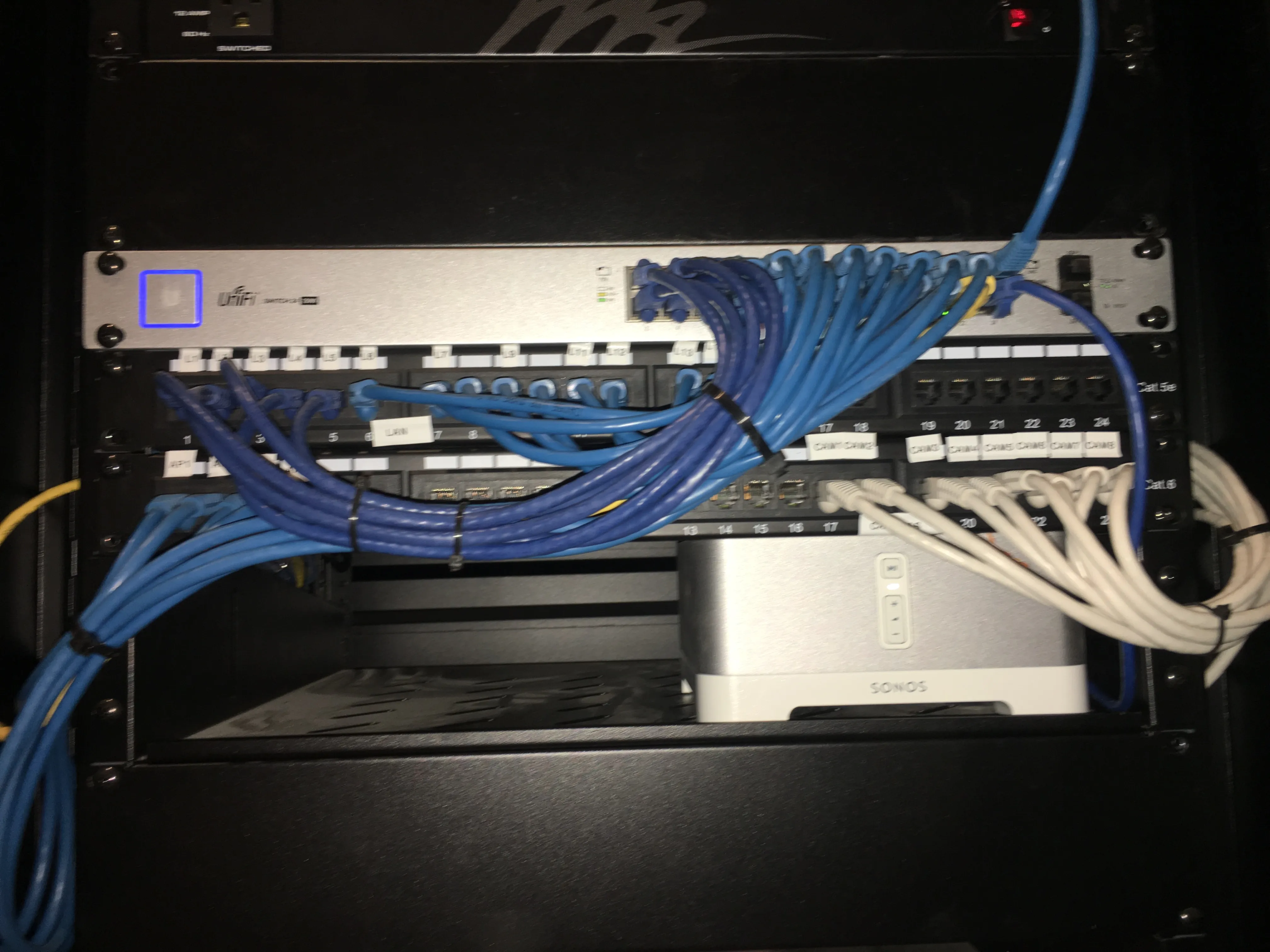 Network switch and patch panels with organized cabling