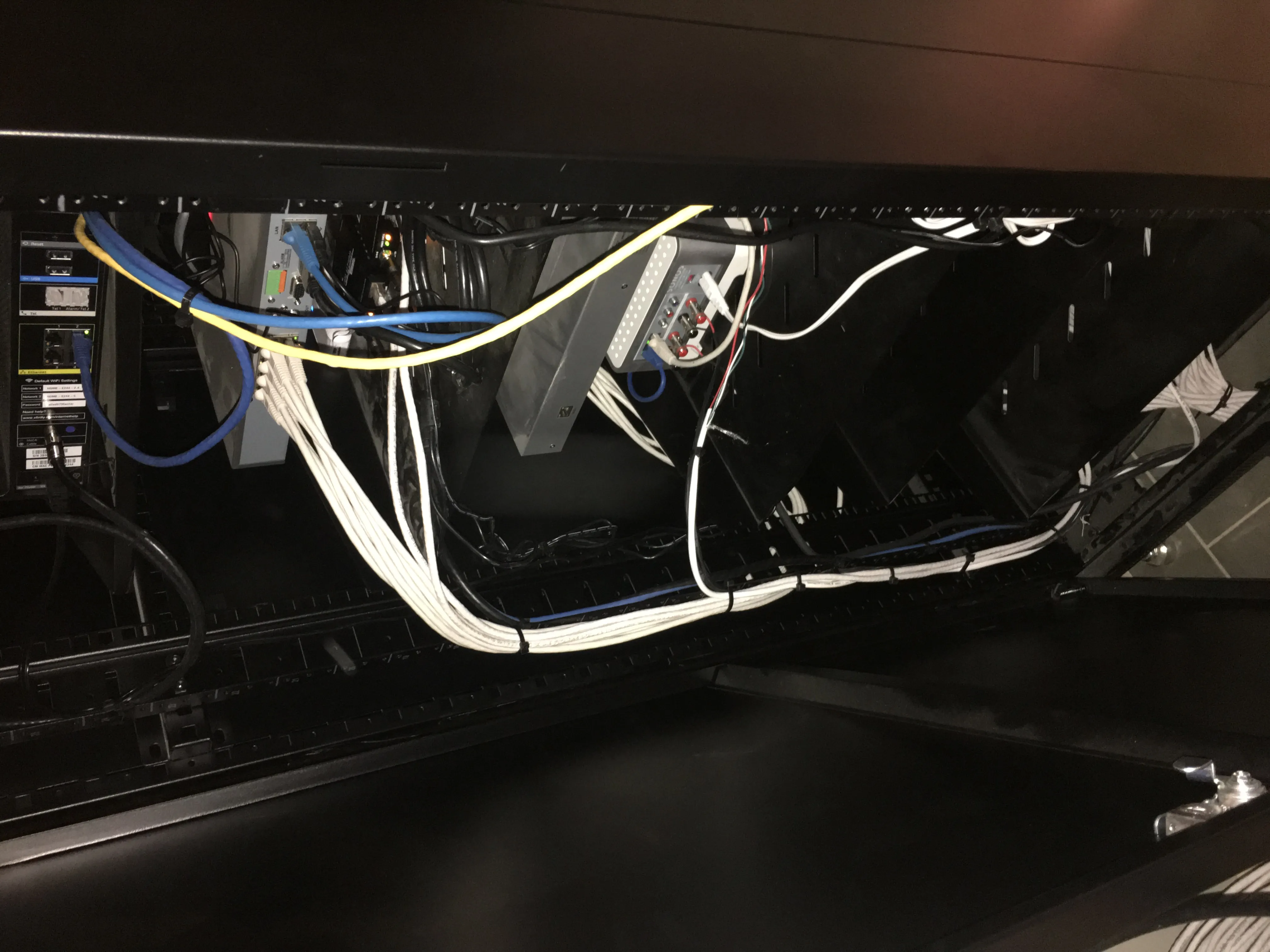 Side view inside the equipment rack showing network and AV cabling